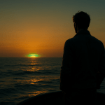 Lone traveler watching the green flash at sunset over the ocean